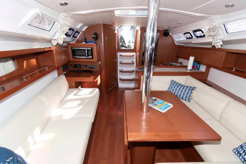 Slide: The Image of Interior of 2015 Beneteau Oceanis 37 yacht with modern furnishings and wood accents. - 12