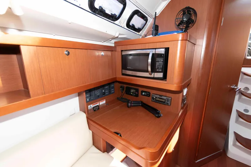Slide: The Image of Interior of 2015 Beneteau Oceanis 37 yacht with microwave and control panel. - 16