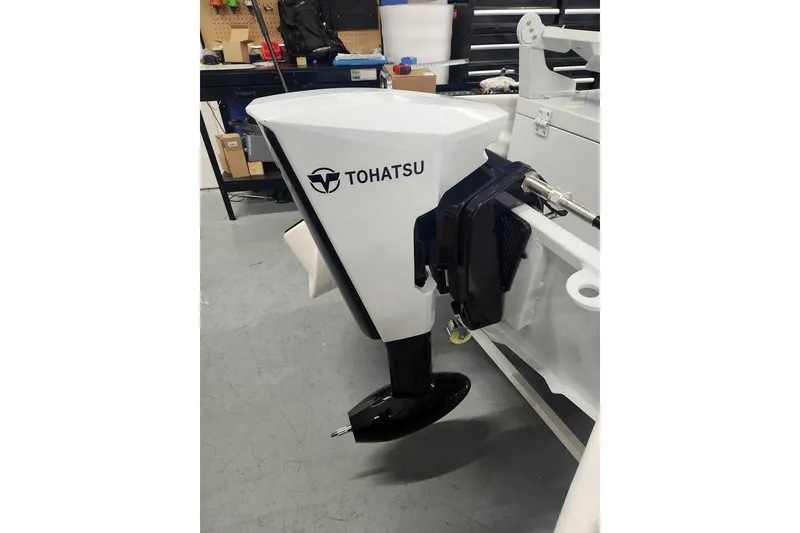 Slide: The Image of 2026 East Marine 320 Electric Tohatsu Alaris outboard motor in workshop setting. - 2