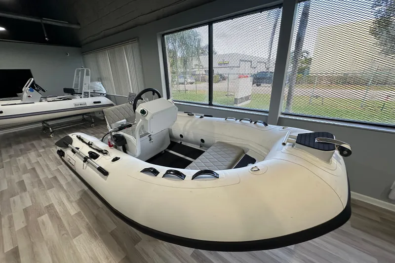 Slide: The Image of 2026 East Marine 320 Electric Tohatsu Alaris inflatable boat in showroom. - 8