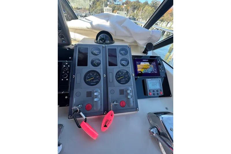 Slide: The Image of Dashboard of a 1983 Tiara Yachts 3100 Open with navigation and control instruments. - 11