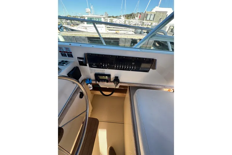 Slide: The Image of Tiara Yachts 3100 Open 1983 dashboard with Simrad navigation system. - 14