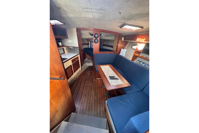 Slide: The Image of 1983 Tiara Yachts 3100 Open helm with steering wheel and control panel. - 16