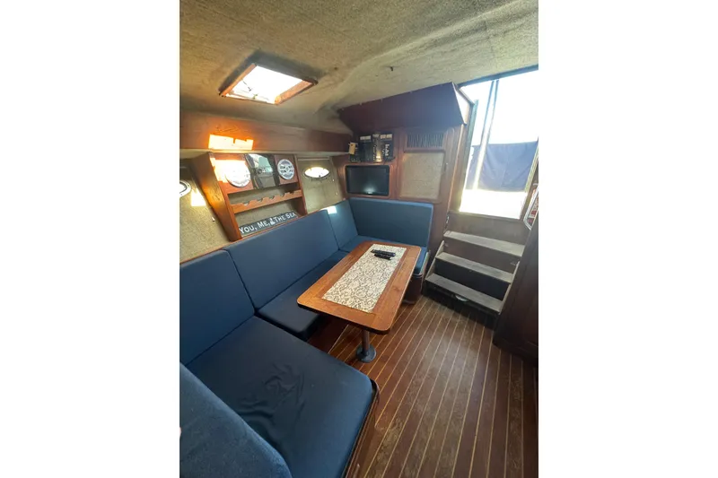 Slide: The Image of 1983 Tiara Yachts 3100 Open helm with steering wheel, controls, and navigation equipment. - 17