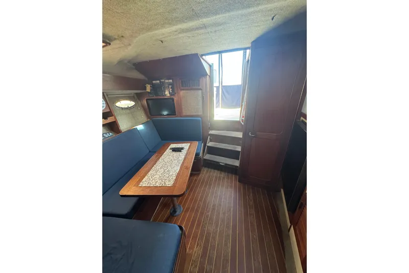 Slide: The Image of Interior of 1983 Tiara Yachts 3100 Open with blue seating and wooden accents. - 18