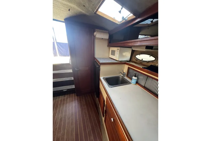 Slide: The Image of Interior of 1983 Tiara Yachts 3100 Open with cozy seating and wooden table. - 19