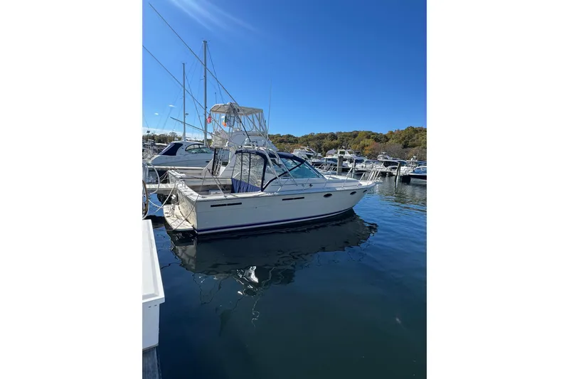 Slide: The Image of 1983 Tiara Yachts 3100 Open cruising on calm blue waters. - 2