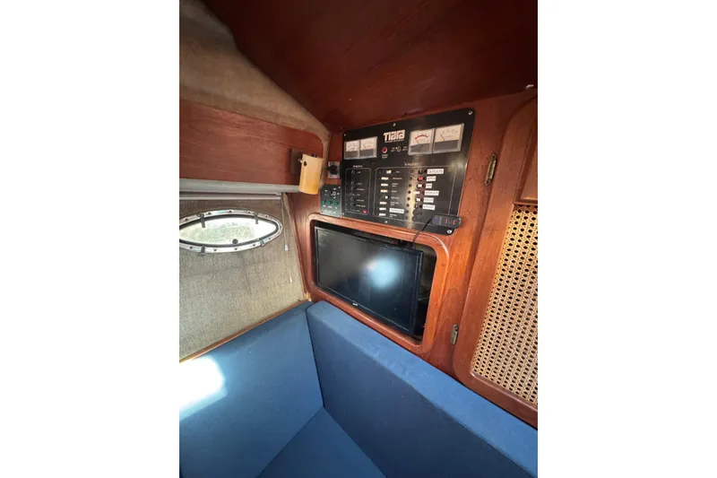 Slide: The Image of 1983 Tiara Yachts 3100 Open galley with sink, microwave, and wooden cabinetry. - 26