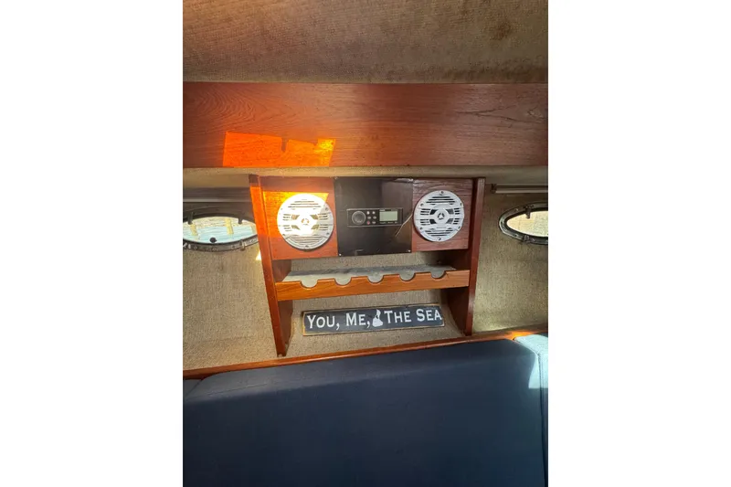 Slide: The Image of 1983 Tiara Yachts 3100 Open cabin interior with control panel and seating. - 28