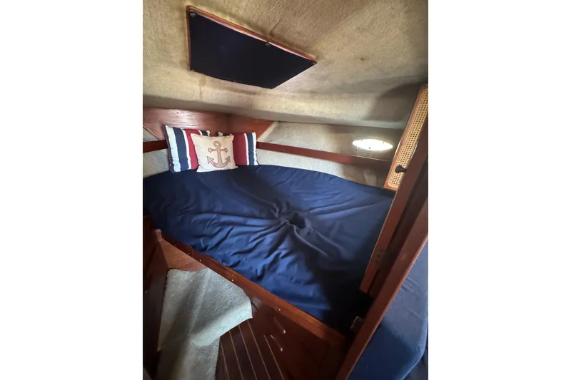 Slide: The Image of 1983 Tiara Yachts 3100 Open cabin interior with speakers and "You, Me, & The Sea" sign. - 30