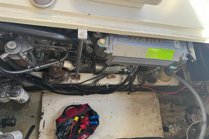 Slide: The Image of 1983 Tiara Yachts 3100 Open cabin interior with nautical-themed bedding and wooden furnishings. - 31