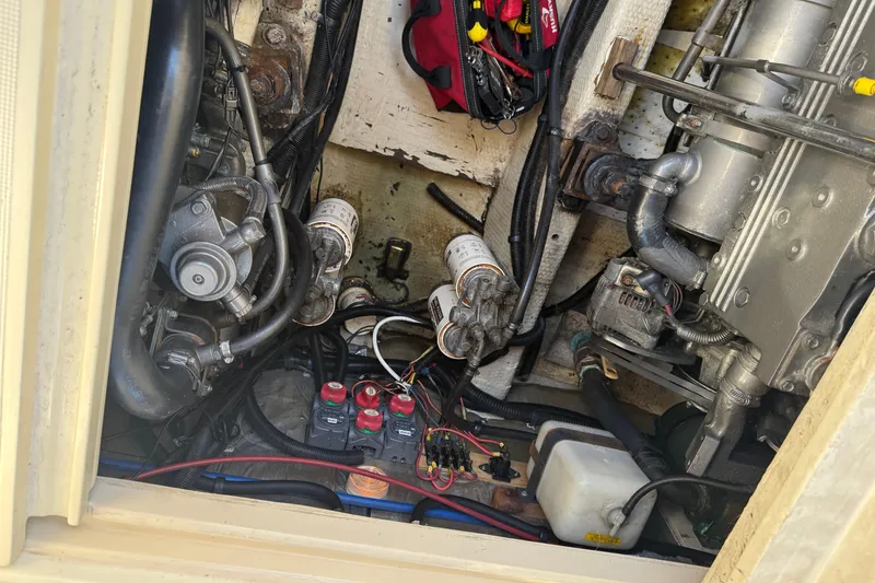 Slide: The Image of 1983 Tiara Yachts 3100 Open cabin interior with blue bedding and nautical-themed pillow. - 32