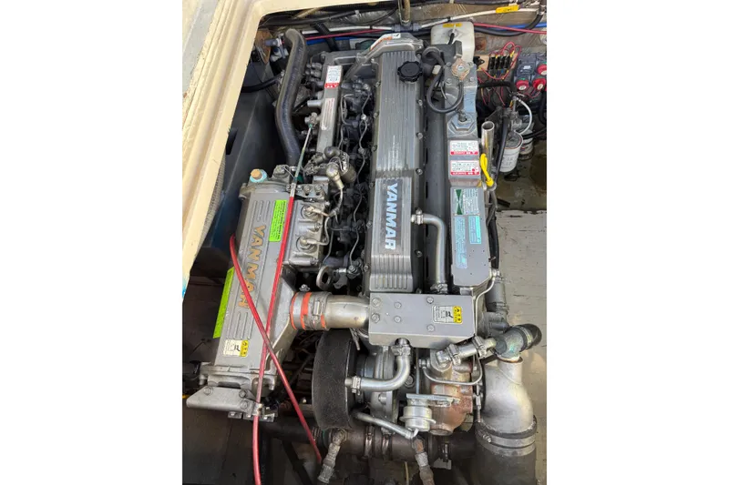 Slide: The Image of Engine compartment of a 1983 Tiara Yachts 3100 Open, featuring a Yanmar engine. - 34