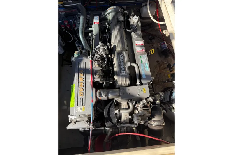 Slide: The Image of Engine compartment of a 1983 Tiara Yachts 3100 Open, featuring dual Yanmar engines. - 35