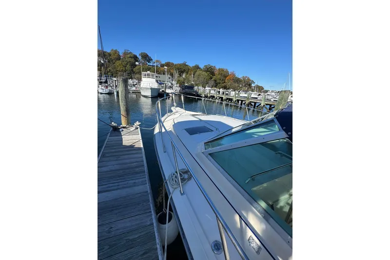 Slide: The Image of 1983 Tiara Yachts 3100 Open boat deck, docked at marina, with ropes and equipment. - 6