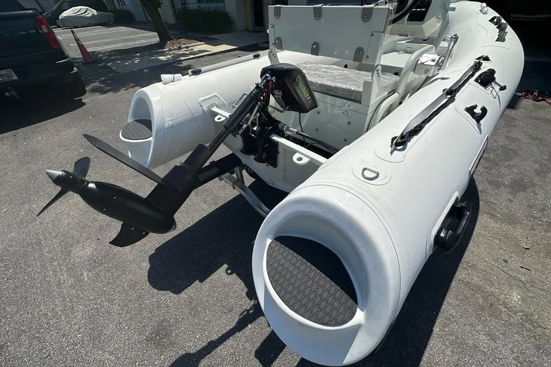 Slide: The Image of Inflatable boat with Linergy electric motor, East Marine NEW 320, 2026 model, parked outdoors. - 1