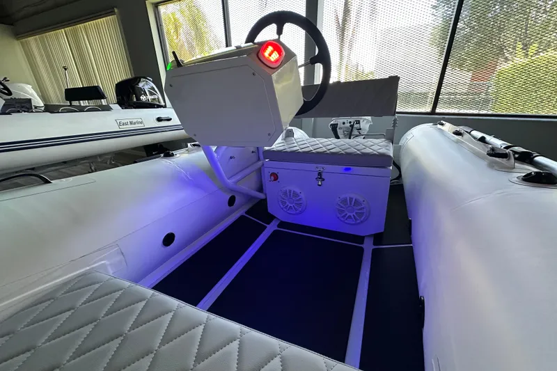 Slide: The Image of 2026 East Marine NEW 320 boat interior with Linergy electric motor, featuring modern design and seating. - 12