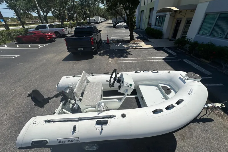 Slide: The Image of Inflatable East Marine boat, model NEW 320, with Linergy electric motor, parked outdoors. - 5