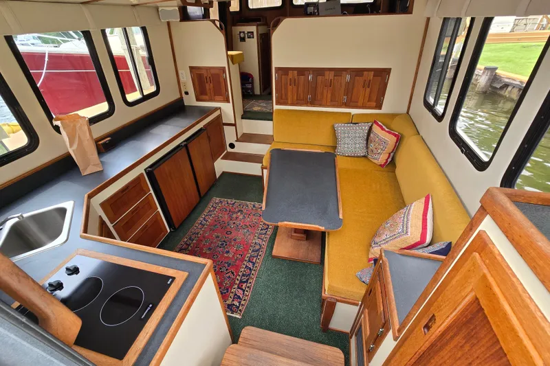 Slide: The Image of Interior of a 2001 Nordic Tug 32 with cozy seating and kitchen area. - 17