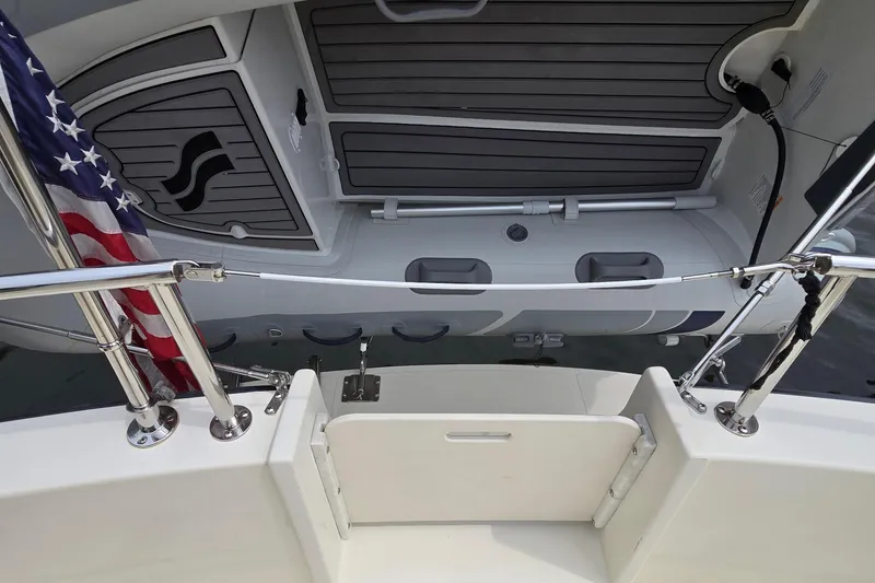 Slide: The Image of Nordic Tug 32 boat deck with American flag, featuring sleek design and modern fittings. - 47