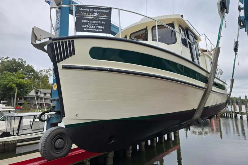 Slide: The Image of 2001 Nordic Tug 32 with Seakeeper being lifted at a marina. - 50