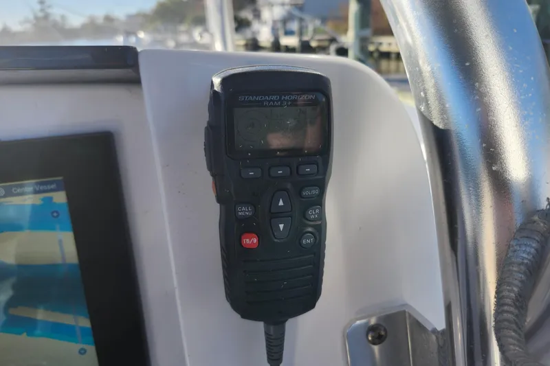 Slide: The Image of Standard Horizon RAM3 radio on 2015 Southport 29 Tournament Edition boat dashboard. - 12