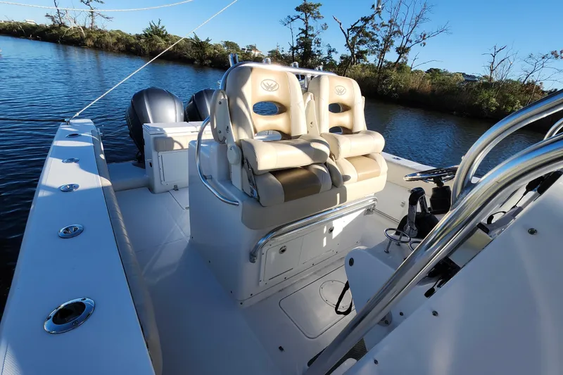 Slide: The Image of 2015 Southport 29 Tournament Edition boat with dual seats and twin engines on a calm river. - 15
