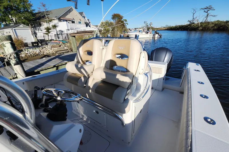 Slide: The Image of 2015 Southport 29 Tournament Edition boat with dual seats, docked by a serene waterfront. - 16
