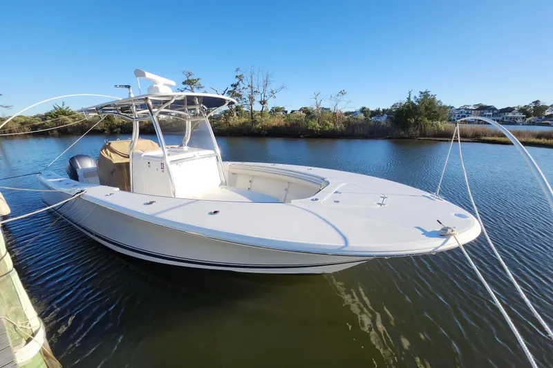 Slide: The Image of 2015 Southport 29 Tournament Edition boat docked on calm water. - 2