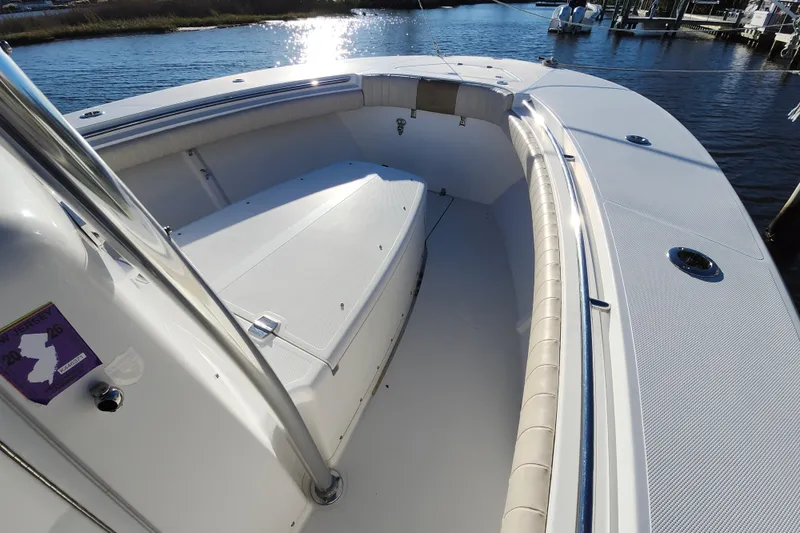 Slide: The Image of 2015 Southport 29 Tournament Edition boat interior with cushioned seating, docked by the water. - 21