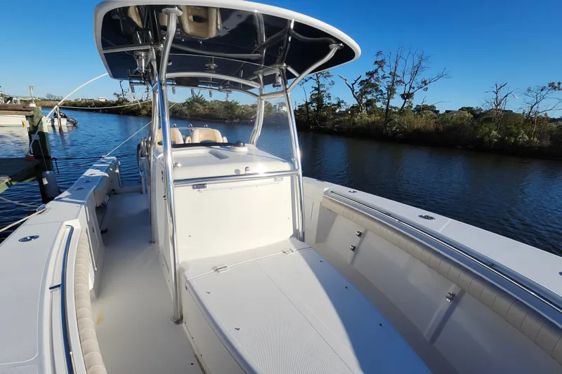 Slide: The Image of 2015 Southport 29 Tournament Edition boat on calm water, featuring spacious deck and sleek design. - 23