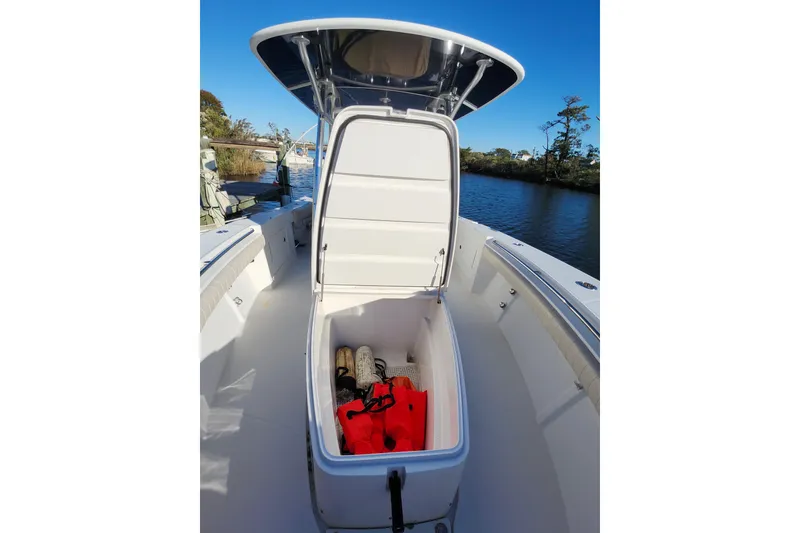 Slide: The Image of 2015 Southport 29 Tournament Edition boat with open storage compartment, life jackets visible. - 25