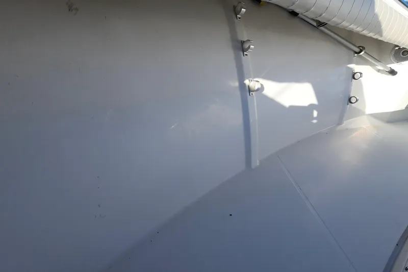 Slide: The Image of Interior view of a 2015 Southport 29 Tournament Edition boat, showcasing clean white surfaces. - 28