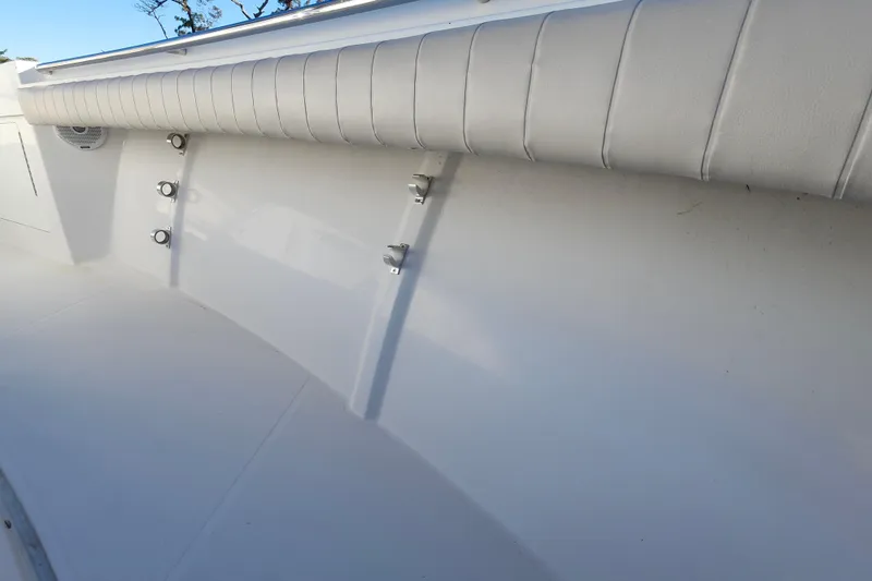 Slide: The Image of 2015 Southport 29 Tournament Edition boat interior with padded side panel and rod holders. - 29
