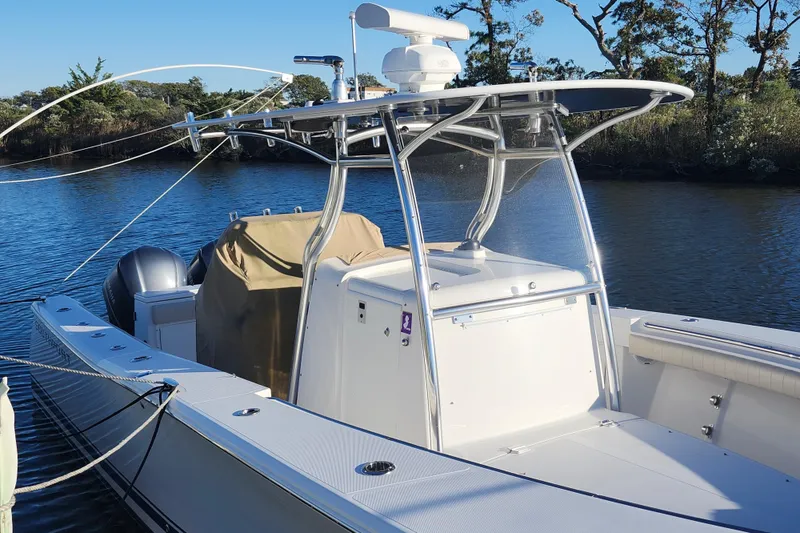 Slide: The Image of 2015 Southport 29 Tournament Edition boat docked on a calm river. - 3