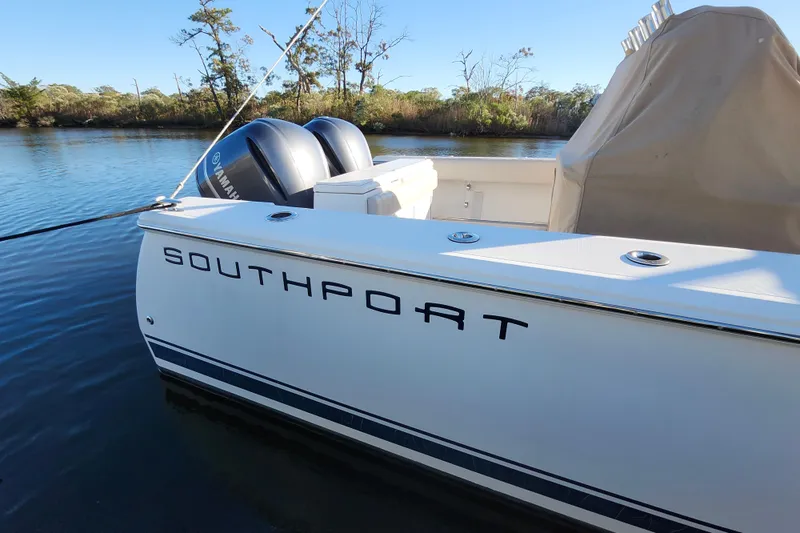 Slide: The Image of 2015 Southport 29 Tournament Edition boat with Yamaha engines on a calm river. - 35