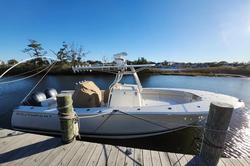 Slide: The Image of 2015 Southport 29 Tournament Edition boat docked by a serene waterfront. - 4