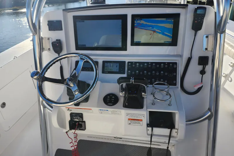 Slide: The Image of 2015 Southport 29 Tournament Edition boat dashboard with navigation screens and controls. - 8