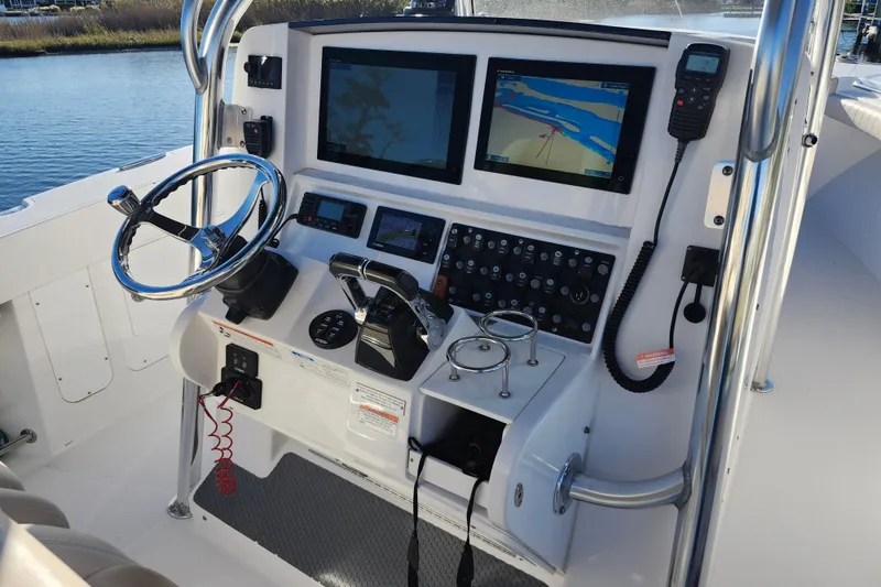 Slide: The Image of 2015 Southport 29 Tournament Edition boat helm with dual navigation screens and controls. - 9