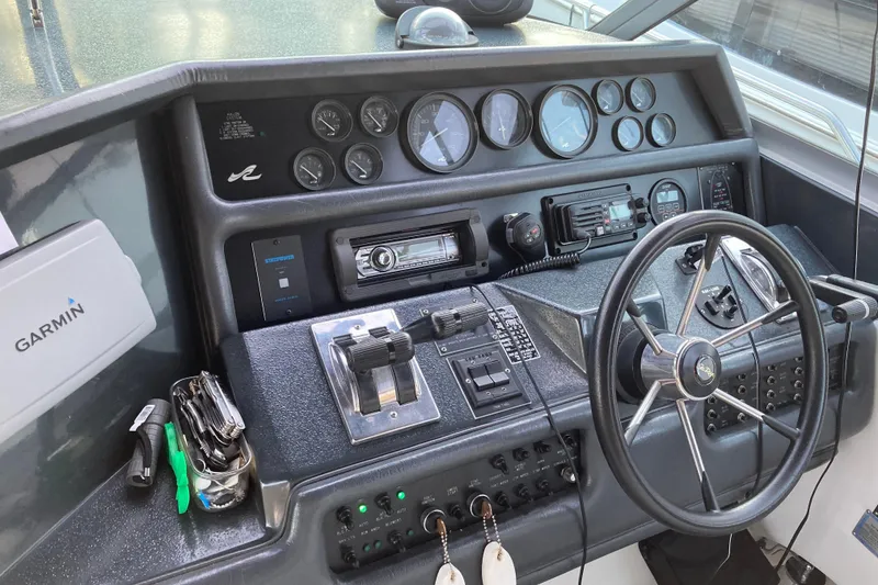 Slide: The Image of 1992 Sea Ray 370 Sundancer helm with Garmin navigation and control instruments. - 1