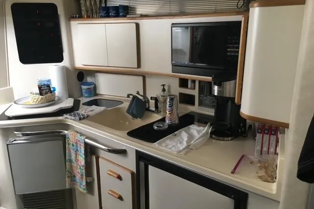 Slide: The Image of Interior kitchen of 1992 Sea Ray 370 Sundancer yacht with modern amenities. - 10