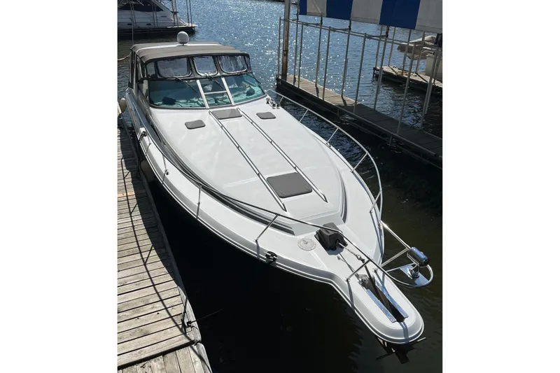 Slide: The Image of 1992 Sea Ray 370 Sundancer docked at marina, sleek design, sunny day. - 11
