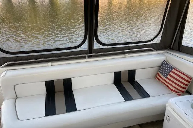 Slide: The Image of Interior of 1992 Sea Ray 370 Sundancer with white seating and American flag pillow. - 3