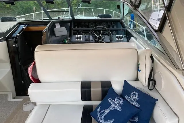 Slide: The Image of 1992 Sea Ray 370 Sundancer cockpit with white seating and nautical-themed cushions. - 4