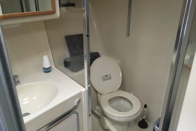 Slide: The Image of Bathroom interior of 1992 Sea Ray 370 Sundancer yacht, featuring sink and toilet. - 8