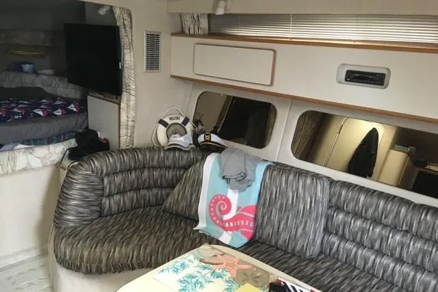 Slide: The Image of Interior of 1992 Sea Ray 370 Sundancer with cozy seating and nautical decor. - 9