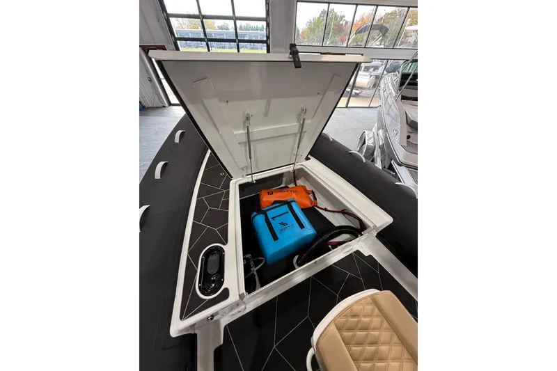Slide: The Image of Open storage compartment of 2026 Highfield Sport 800 boat, showcasing interior equipment. - 10