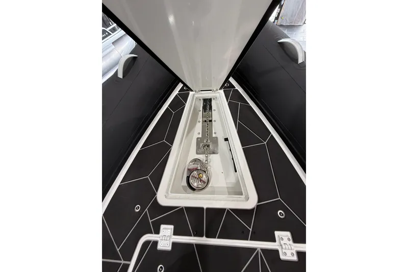 Slide: The Image of 2026 Highfield Sport 800 boat anchor compartment with sleek black and white design. - 12