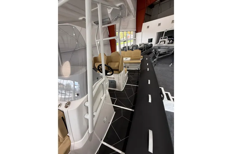Slide: The Image of 2026 Highfield Sport 800 boat interior with modern seating and steering console. - 16