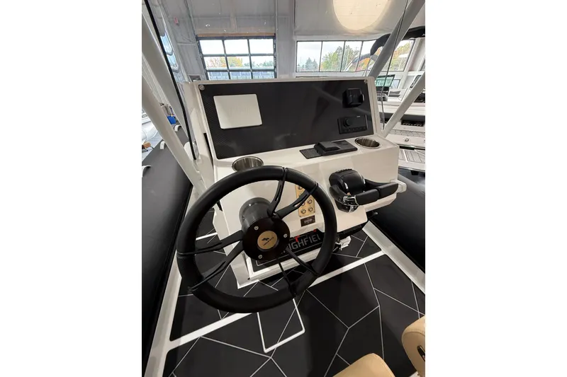Slide: The Image of Steering console of 2026 Highfield Sport 800 boat, featuring modern controls and design. - 19